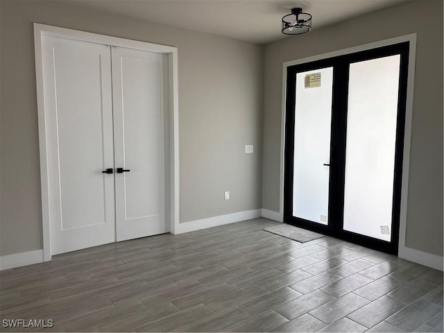 interior space featuring baseboards and wood finished floors