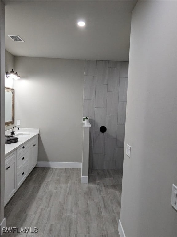 full bathroom featuring vanity, wood finished floors, visible vents, and recessed lighting