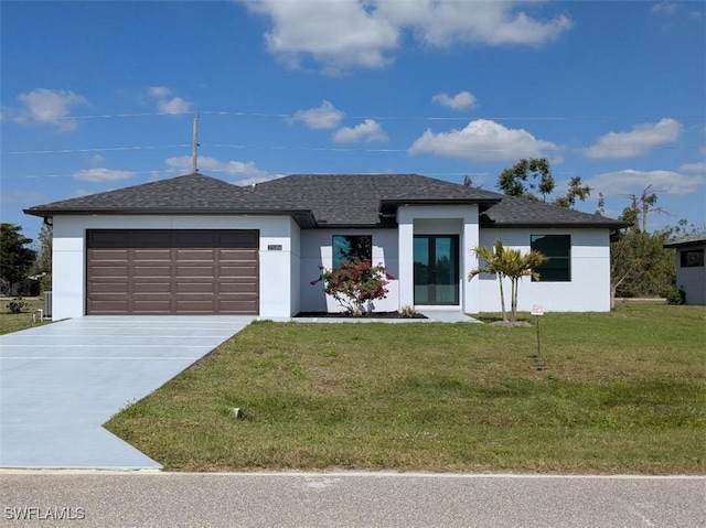 view of front of home featuring a garage, stucco siding, a front yard, and concrete driveway