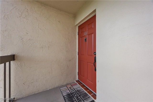 4372 27th Ct SW Unit 301, Naples, FL 34116 - view of exterior entry featuring stucco siding