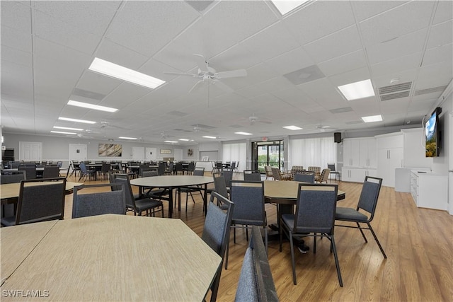 4372 27th Ct SW Unit 301, Naples, FL 34116 - dining room featuring wood finished floors, a ceiling fan, and a paneled ceiling