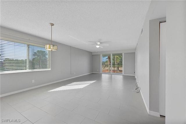 4372 27th Ct SW Unit 301, Naples, FL 34116 - spare room with a textured ceiling, baseboards, and a ceiling fan