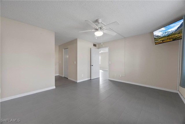 4372 27th Ct SW Unit 301, Naples, FL 34116 - empty room featuring a ceiling fan, a textured ceiling, and baseboards