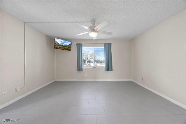 4372 27th Ct SW Unit 301, Naples, FL 34116 - empty room featuring a ceiling fan, a textured ceiling, baseboards, and tile patterned floors