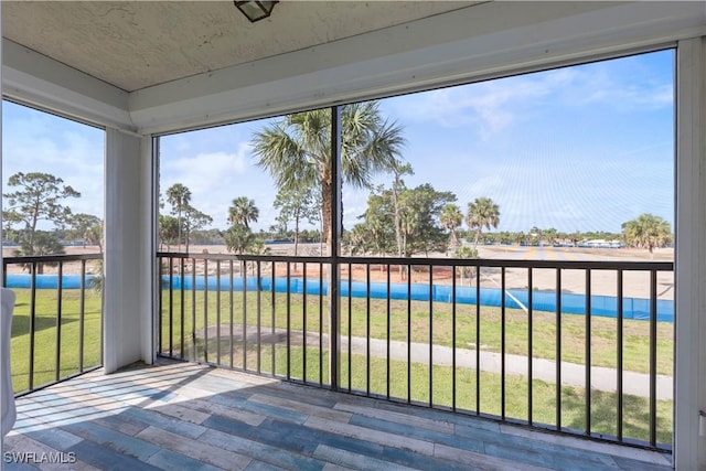 4372 27th Ct SW Unit 301, Naples, FL 34116 - unfurnished sunroom featuring wood finished floors