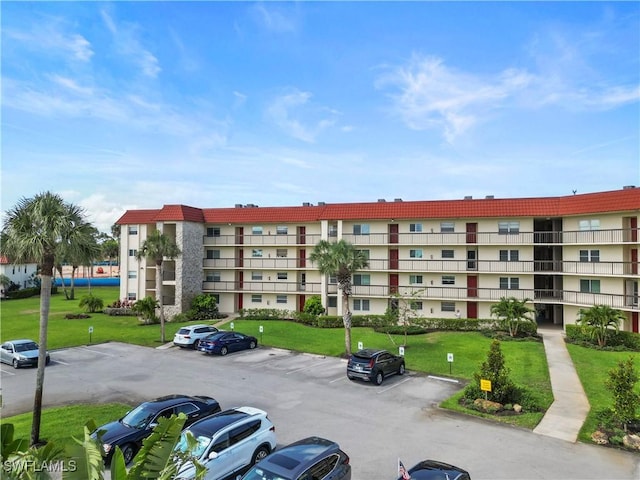 4372 27th Ct SW Unit 301, Naples, FL 34116 - view of apartment building / complex featuring uncovered parking