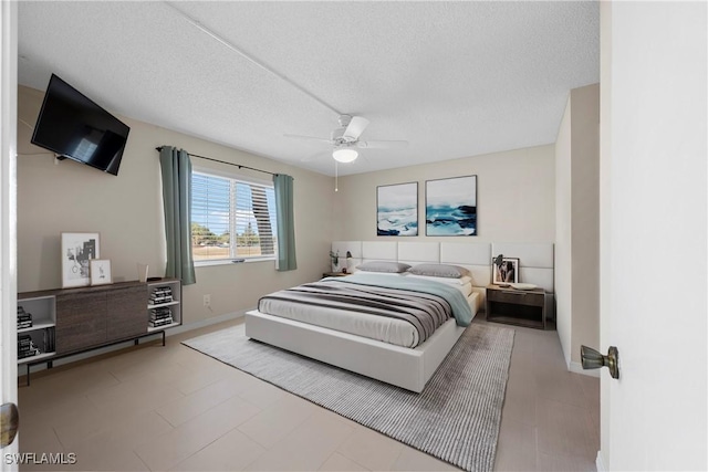 4372 27th Ct SW Unit 301, Naples, FL 34116 - bedroom featuring a textured ceiling, ceiling fan, and baseboards