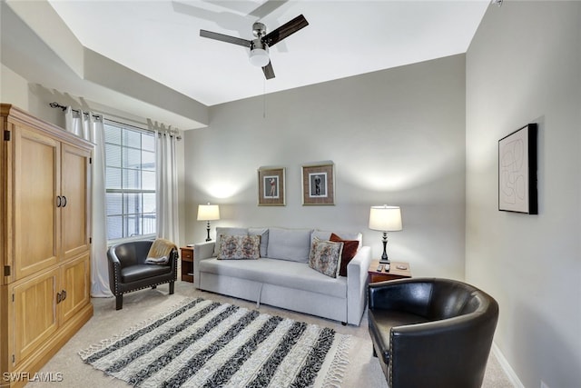 carpeted living room with ceiling fan