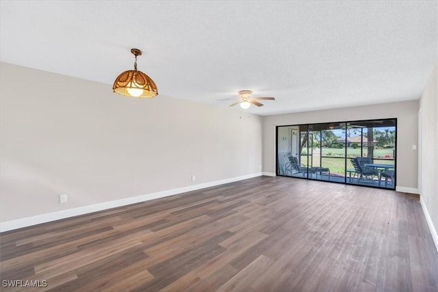 unfurnished room with ceiling fan, a textured ceiling, and dark hardwood / wood-style flooring