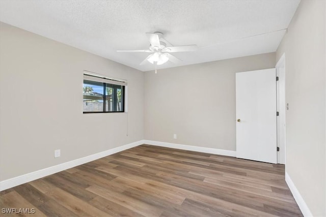 spare room featuring ceiling fan, hardwood / wood-style floors, and a textured ceiling