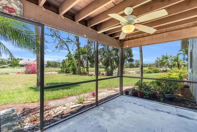 unfurnished sunroom with ceiling fan