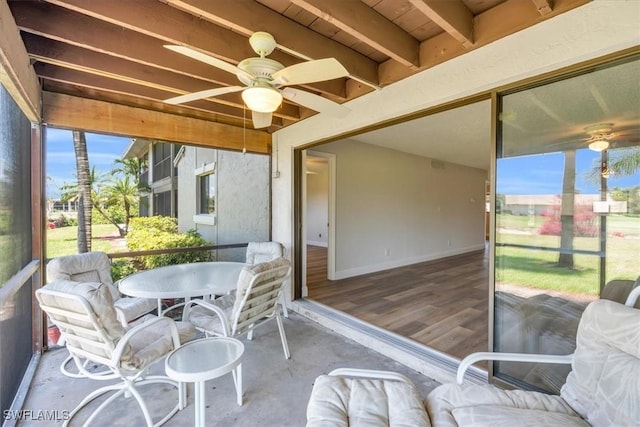 sunroom / solarium featuring ceiling fan