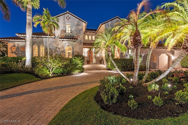 mediterranean / spanish-style house with a tiled roof and stucco siding