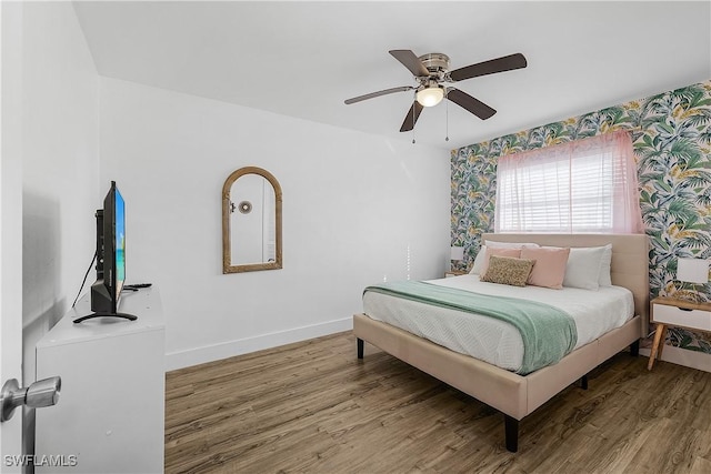 bedroom featuring hardwood / wood-style flooring and ceiling fan