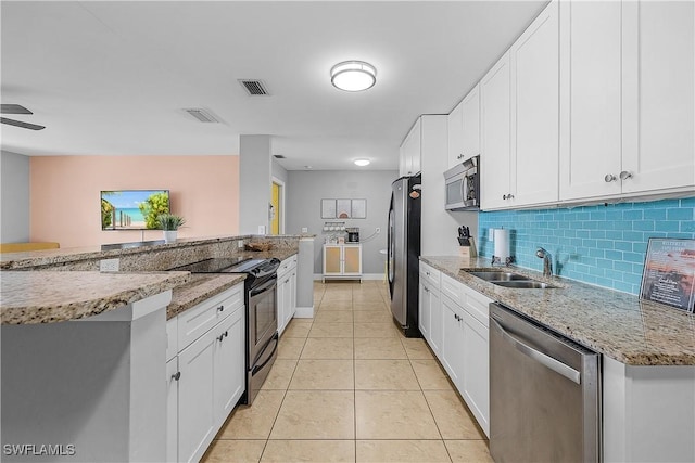 kitchen featuring light stone countertops, appliances with stainless steel finishes, and white cabinets