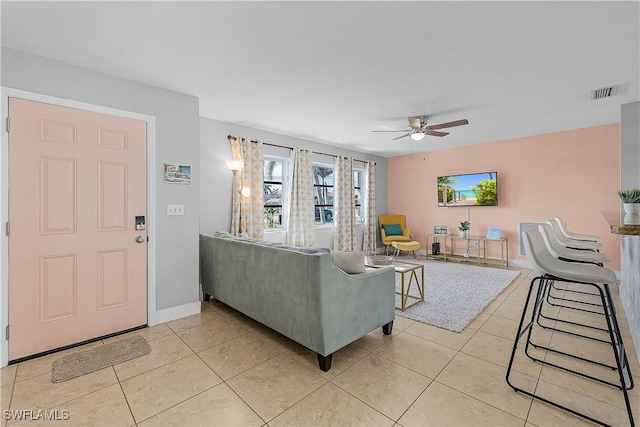 living room with light tile patterned floors and ceiling fan