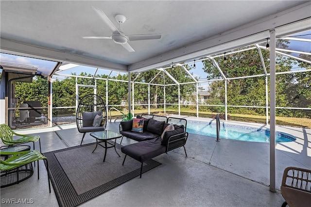 view of swimming pool with a lanai, ceiling fan, and a patio area