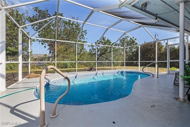 view of swimming pool with a lanai and a patio