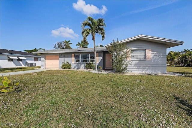 ranch-style home with cooling unit, a garage, and a front yard