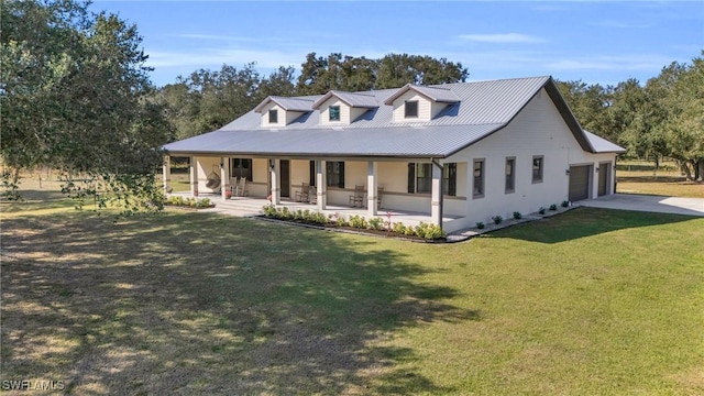 view of front facade with a garage, a front yard, and a porch