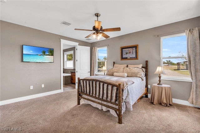 carpeted bedroom featuring ensuite bath and ceiling fan