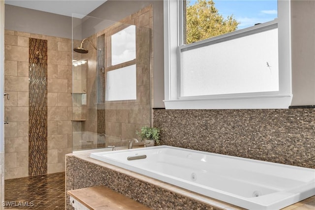 bathroom featuring separate shower and tub