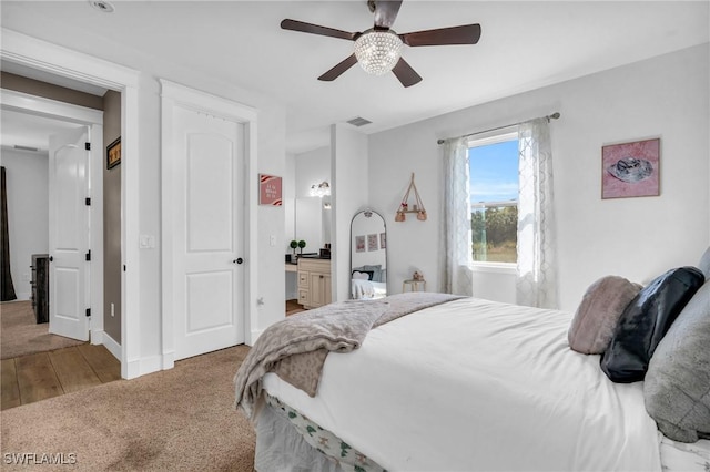 bedroom featuring carpet floors, ceiling fan, and ensuite bathroom