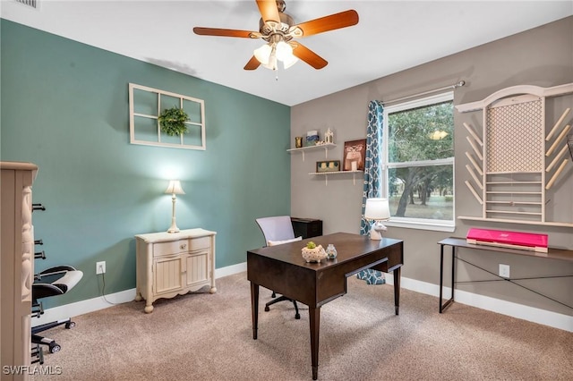 office space featuring ceiling fan and light carpet