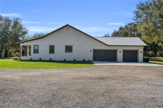 view of front of property with a garage and a front lawn