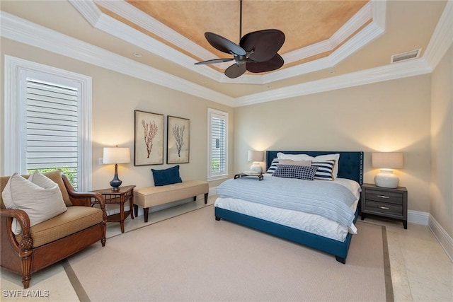 bedroom with a tray ceiling, ornamental molding, and ceiling fan