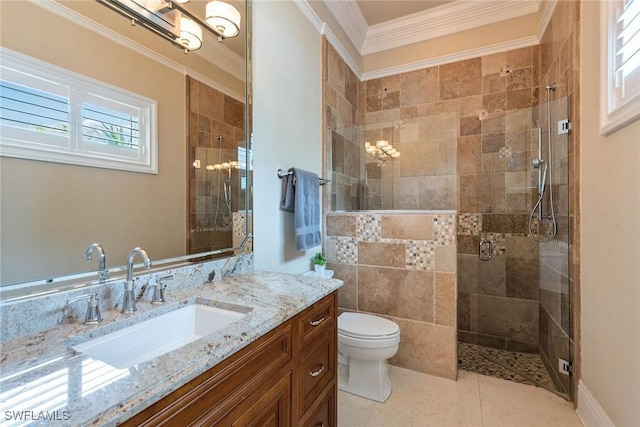 bathroom with tile patterned flooring, vanity, ornamental molding, toilet, and walk in shower