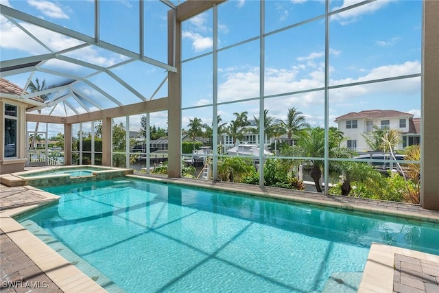 view of swimming pool with an in ground hot tub and glass enclosure