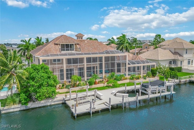 rear view of property featuring a water view and glass enclosure