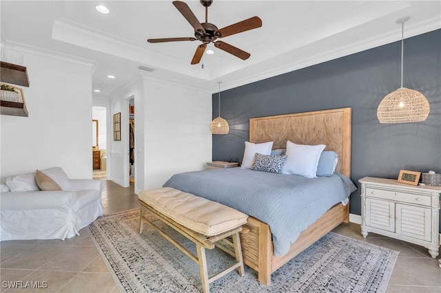 bedroom featuring crown molding, ceiling fan, a tray ceiling, and light tile patterned floors