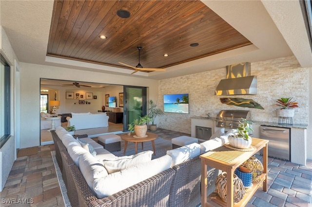 living room featuring a raised ceiling, wooden ceiling, and ceiling fan