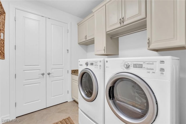 washroom with cabinets, light tile patterned flooring, and independent washer and dryer