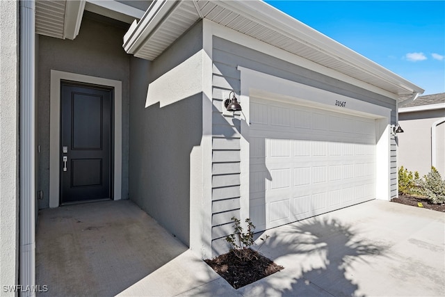 doorway to property with a garage