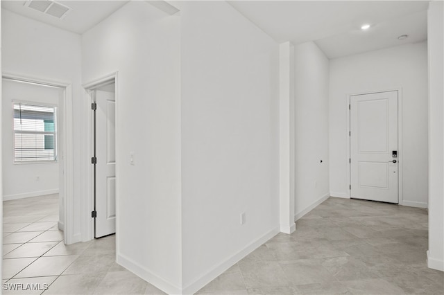 hall featuring light tile patterned floors