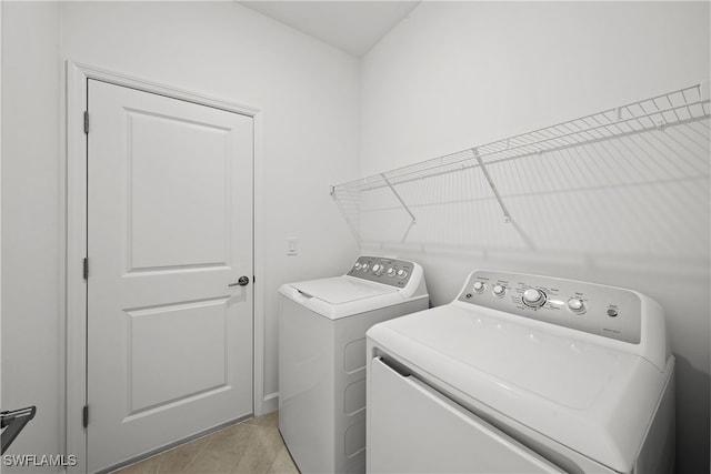 clothes washing area featuring separate washer and dryer