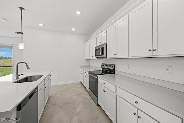 kitchen with stainless steel appliances, sink, hanging light fixtures, and white cabinets