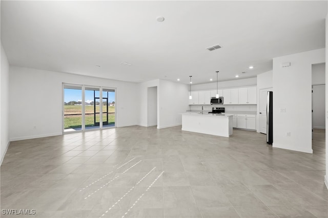 unfurnished living room featuring sink and light tile patterned flooring