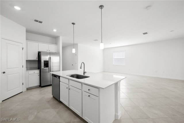 kitchen featuring sink, white cabinetry, hanging light fixtures, stainless steel appliances, and an island with sink