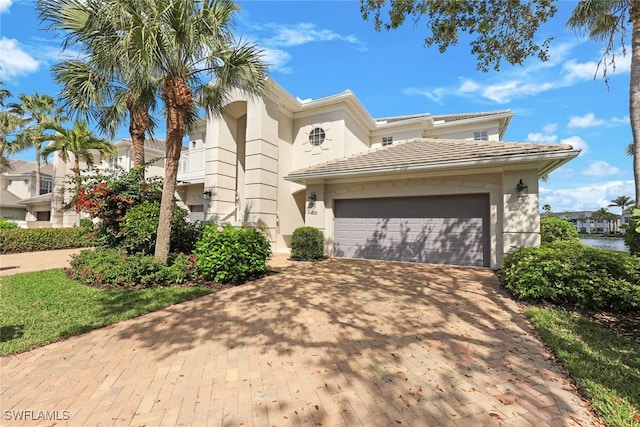 mediterranean / spanish home featuring a garage