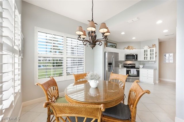 dining room featuring light tile patterned floors and an inviting chandelier