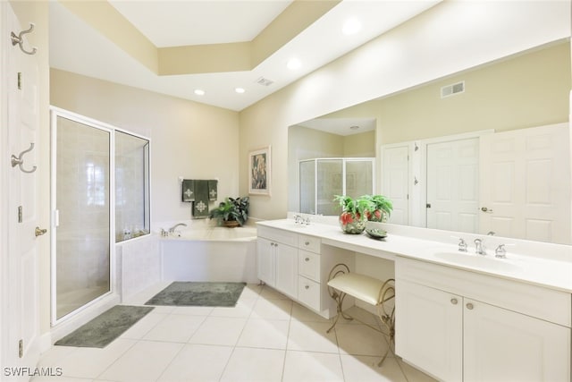 bathroom featuring vanity, tile patterned floors, independent shower and bath, and a raised ceiling