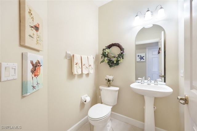 bathroom with tile patterned flooring and toilet