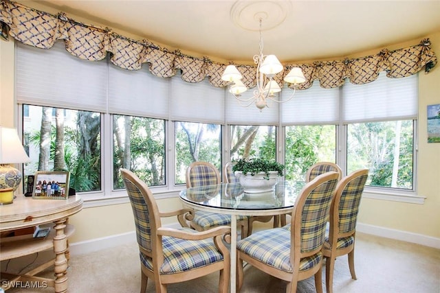 dining area with a notable chandelier and light colored carpet