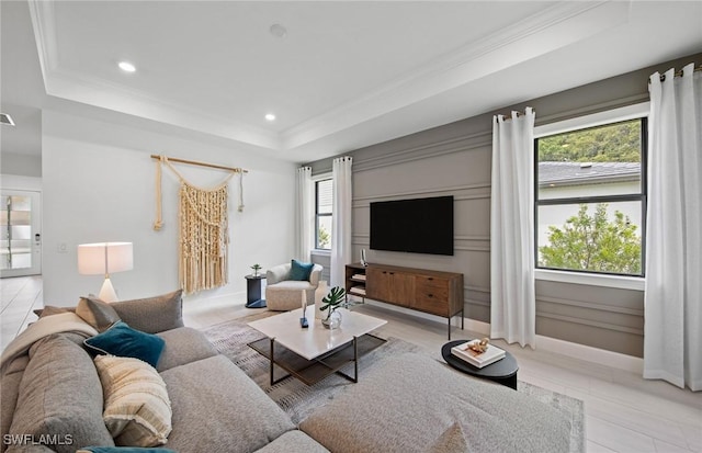 living room featuring ornamental molding and a raised ceiling