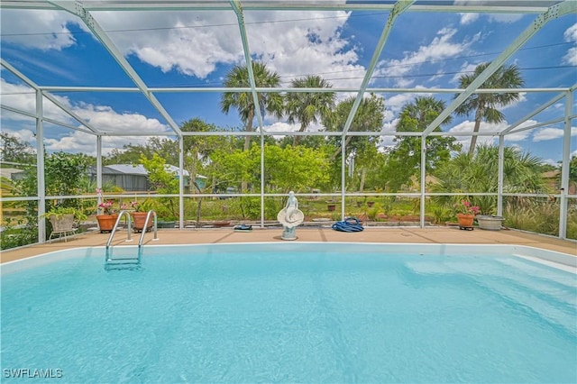 view of swimming pool with a lanai and a patio area