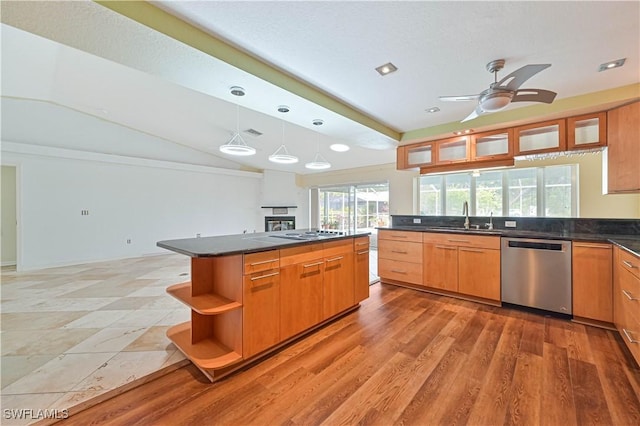 kitchen with sink, a center island, vaulted ceiling, hanging light fixtures, and dishwasher